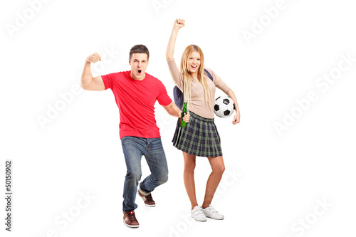 Photo: Full length portrait of a male and female football supporters Full length portrait of a male and female football supporters