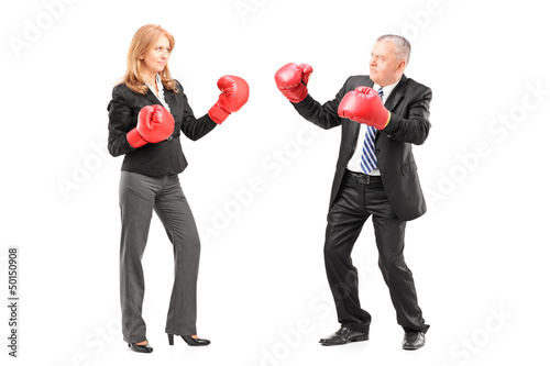 Photo: Full length portrait of a mature businessman and businesswoman w Full length portrait of a mature businessman and businesswoman w