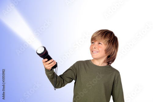 Photo: Child with a flashlight looking for something Child with a flashlight looking for something