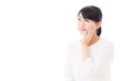 a young asian woman making up