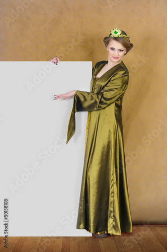 Photo: Young pretty princess holding a blank placard Young pretty princess holding a blank placard