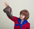 Unhappy woman holding a dirty shoe.