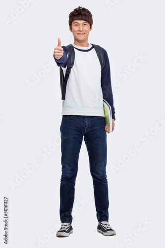 Photo: Young Asian student showing thumb Young Asian student showing thumb