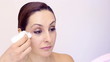 young woman removing make-up