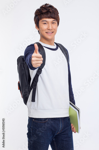 Photo: Young Asian student showing thumb Young Asian student showing thumb