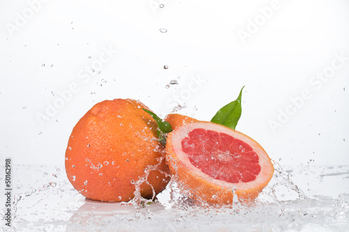 Photo: water splash in kiwi fruit isolated on white bacground water splash in kiwi fruit isolated on white bacground