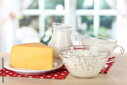 Photo: Dairy products on napkin on table in kitchen Dairy products on napkin on table in kitchen