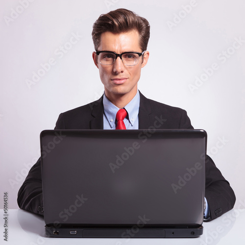 Photo: working on laptop at desk working on laptop at desk