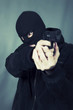 Photo: black dressed man with gun black dressed man with gun