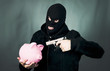 Photo: man with a gun and piggy bank man with a gun and piggy bank