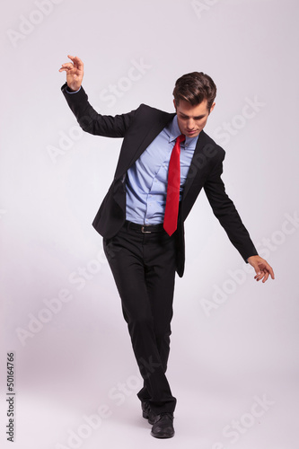 Photo: young business man balancing young business man balancing