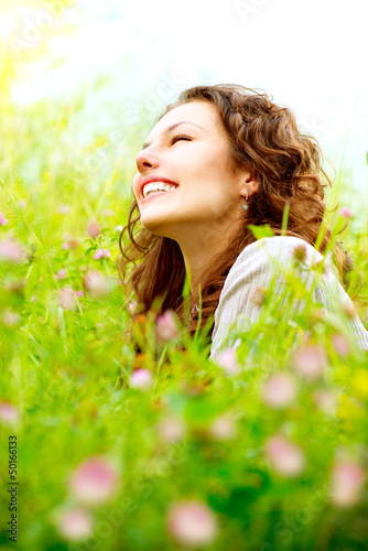 Photo: Beautiful Young Woman Outdoors. Enjoy Nature. Meadow Beautiful Young Woman Outdoors. Enjoy Nature. Meadow