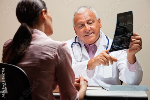 Photo: Radiologist Explaining X-ray To Patient Radiologist Explaining X-ray To Patient