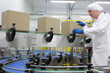 caucasian man worker in white apron  at packing line in factory
