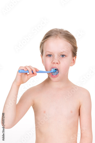 Photo: Naked smiling young girl brushing teeth with toothpaste Naked smiling young girl brushing teeth with toothpaste