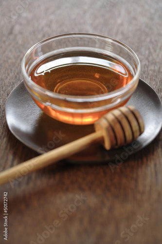 Photo: Honey in bowl with dipper Honey in bowl with dipper