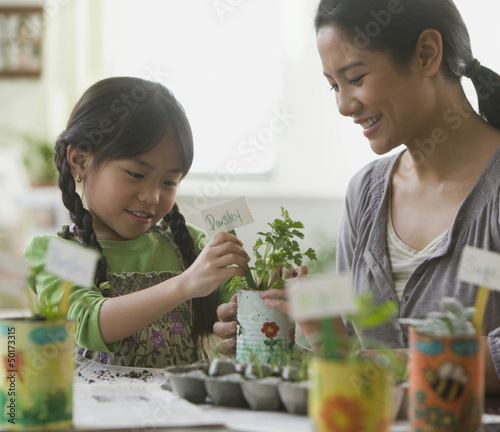 Photo: Asian mother and daughter potting plants Asian mother and daughter potting plants