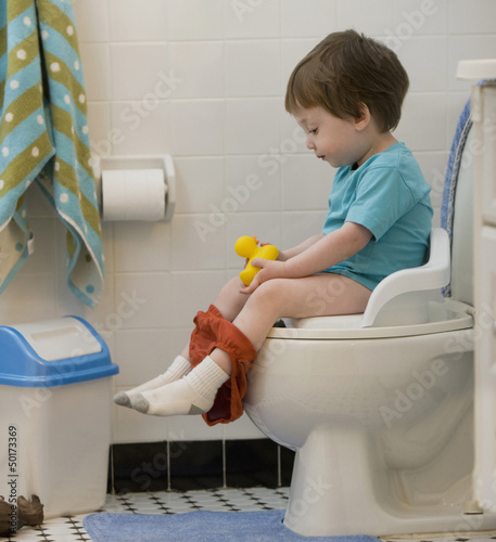 Photo: Mixed race boy using toilet Mixed race boy using toilet