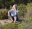 relaxed 60's woman happy to be alone and thinking outdoors