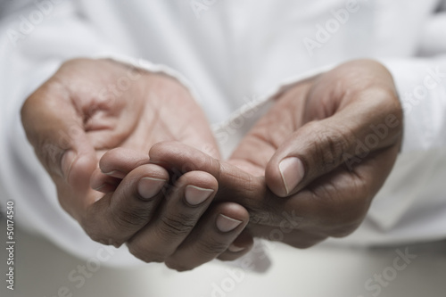 Photo: Close up of mixed race man's hands Close up of mixed race man's hands
