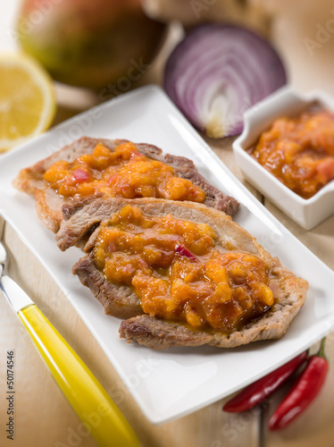 Photo: grilled steak with mango sauce, selective focus grilled steak with mango sauce, selective focus