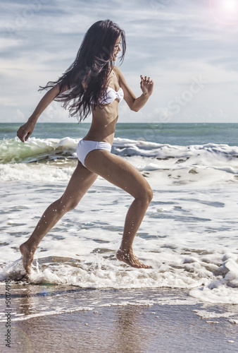 Photo: Sexy Woman Girl in Bikini Running on Beach Sexy Woman Girl in Bikini Running on Beach