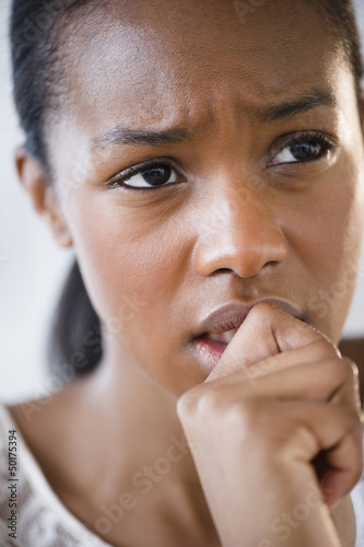 Photo: Anxious Black woman frowning Anxious Black woman frowning
