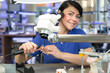 Photo: Dental technician producing a prosthesis under a microscope Dental technician producing a prosthesis under a microscope