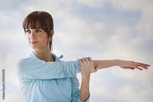 Photo: Caucasian woman stretching before exercise Caucasian woman stretching before exercise