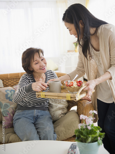 Photo: Japanese daughter bringing mother breakfast on a tray Japanese daughter bringing mother breakfast on a tray