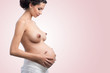 beautiful young pregnant woman with bare breasts
