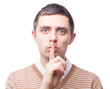 A man holds his index finger near the mouth