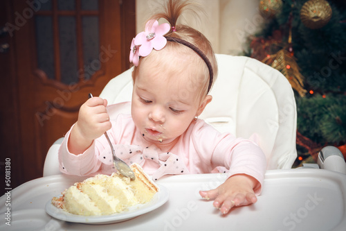 Photo: Little girl with a sweet cake in birthday Little girl with a sweet cake in birthday