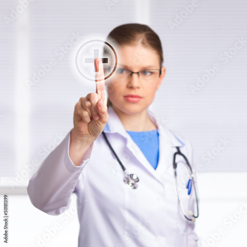 Photo: Beautiful Woman Doctor Touching Medical Symbol Beautiful Woman Doctor Touching Medical Symbol