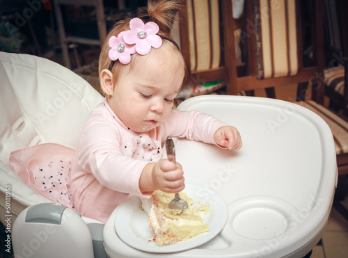 Photo: Little girl with a sweet cake in birthday Little girl with a sweet cake in birthday
