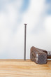 Hammer and nail with wooden board