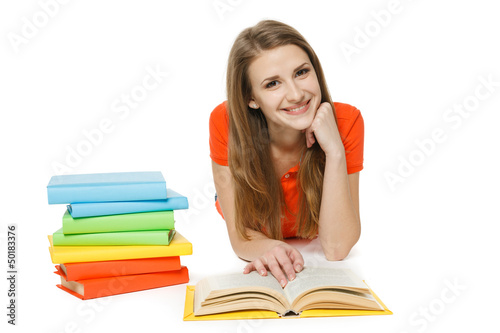 Photo: Happy woman reading the book lying on the floor Happy woman reading the book lying on the floor