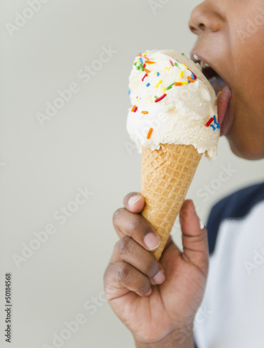 Photo: Black boy licking ice cream cone Black boy licking ice cream cone