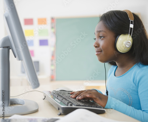 Photo: Black student using computer in classroom Black student using computer in classroom