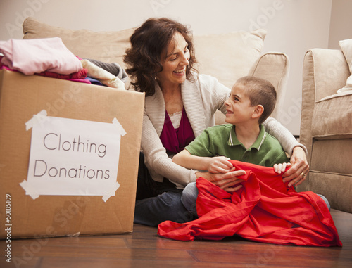 Photo: Caucasian grandmother and granddaughter donating clothing Caucasian grandmother and granddaughter donating clothing