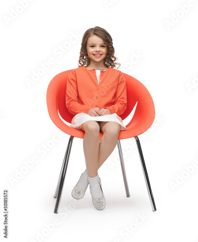 Photo: pre-teen girl in casual clothes sitting on chair pre-teen girl in casual clothes sitting on chair