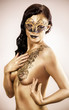 Photo: woman in golden paint with drawings on the body woman in golden paint with drawings on the body