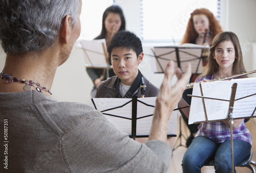 Photo: Teacher and students in music class Teacher and students in music class