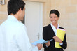 Agent with a client outside a front door