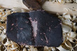 Emery cloth, an old hammer, board and wood shavings