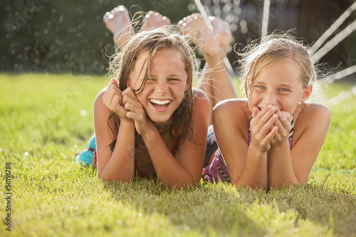Photo: Caucasian girls laying in the grass Caucasian girls laying in the grass