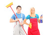 Male and female cleaners with cleaning supplies posing