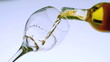 White wine pouring into a glass low angle view