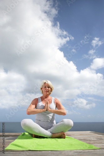 Photo: Woman practicing yoga outdoors Woman practicing yoga outdoors