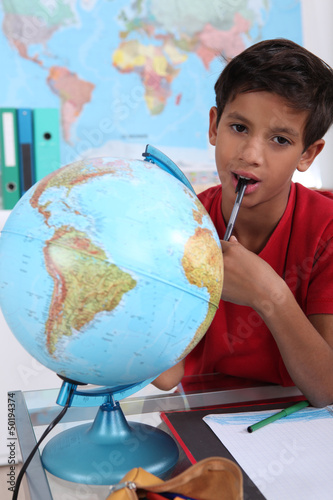Photo: Little boy in classroom, looking bored Little boy in classroom, looking bored